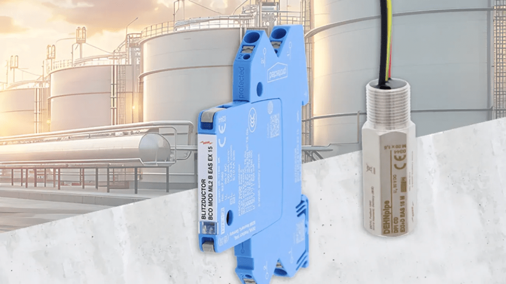 Two electronic components in front of an industrial facility with large storage tanks and a cloudy sky.