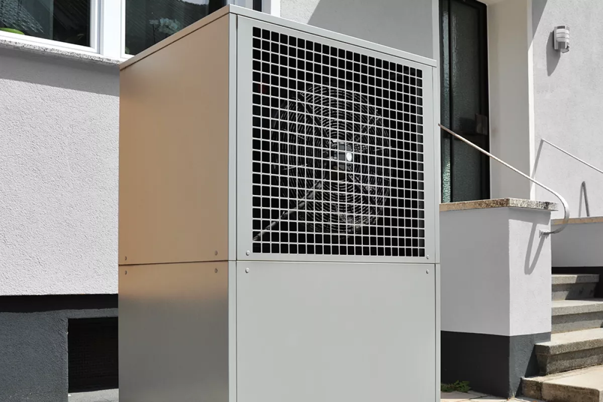 Air source heat pump in front of a house